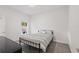 Neat bedroom with a comfortable bed, soft carpet and natural light filtering through a window at 851 W 24Th Pl, Sanford, FL 32771