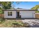 Charming single-story home featuring brick accents, a well-maintained lawn, and an attached two-car garage at 851 W 24Th Pl, Sanford, FL 32771