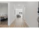 Bright hallway with modern lighting and neutral wood flooring, leading to various rooms with natural light at 851 W 24Th Pl, Sanford, FL 32771