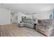 Open-concept living space features hardwood floors, modern furniture, and a bright, airy atmosphere at 851 W 24Th Pl, Sanford, FL 32771