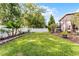 Expansive backyard with lush green lawn, a privacy fence, and tropical banana trees for a serene outdoor space at 9054 Sandwood Way, Orlando, FL 32832