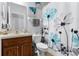 Bathroom featuring a wood vanity, toilet, shower with floral curtain, and vanity mirror at 9054 Sandwood Way, Orlando, FL 32832