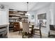 Cozy dining area featuring a modern light fixture, rustic wood accent wall, and natural light at 9054 Sandwood Way, Orlando, FL 32832
