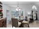 Bright dining area with views to the backyard and a glass table with four chairs at 9054 Sandwood Way, Orlando, FL 32832