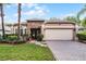 Charming single-story home featuring a stone facade, manicured lawn, and a spacious two-car garage at 9054 Sandwood Way, Orlando, FL 32832