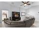 Bright living room with ceiling fan, entertainment center, and adjacent dining area at 9054 Sandwood Way, Orlando, FL 32832