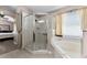This bathroom features an enclosed glass shower and a large soaking tub at 9054 Sandwood Way, Orlando, FL 32832