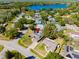 Aerial view of home near a lake in a neighborhood filled with mature trees and foliage at 9501 Holbrook Dr, Orlando, FL 32817