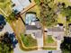 Aerial view of home with the property outlined in red showing surrounding land and the screen enclosed pool at 9501 Holbrook Dr, Orlando, FL 32817