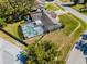 Aerial view of the home, including the pool, screened enclosure, and surrounding landscaping at 9501 Holbrook Dr, Orlando, FL 32817
