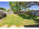 A large, green backyard with a wooden fence and a screened pool area, perfect for Gathering enjoyment at 9501 Holbrook Dr, Orlando, FL 32817
