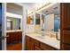 This bathroom includes a vanity, decorative lighting, and adjoining toilet and shower area at 9501 Holbrook Dr, Orlando, FL 32817