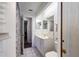 Hall bathroom with vanity, toilet, and tiled shower behind sliding shower curtain at 9501 Holbrook Dr, Orlando, FL 32817