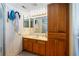 This bathroom includes a vanity, decorative lighting, and a linen closet at 9501 Holbrook Dr, Orlando, FL 32817