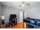 This bedroom features a ceiling fan, a TV on a shelf, and a bed with space themed bedding at 9501 Holbrook Dr, Orlando, FL 32817