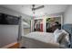 Relaxing bedroom with closet, television, and natural light from the window at 9501 Holbrook Dr, Orlando, FL 32817
