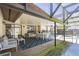 Covered patio with furniture and dining, leading to a pool area at 9501 Holbrook Dr, Orlando, FL 32817
