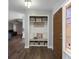 Open-concept entryway features a built-in bench and shelving, with hardwood floors that lead to the living room at 9501 Holbrook Dr, Orlando, FL 32817