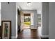 Inviting entryway with hardwood floors, gray walls, and a view of the front yard through the open front door at 9501 Holbrook Dr, Orlando, FL 32817