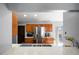 Kitchen featuring wood cabinets, stainless steel appliances, and a view into the backyard at 9501 Holbrook Dr, Orlando, FL 32817