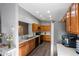 Bright kitchen features wood cabinets, stainless steel appliances, and hard surface countertops at 9501 Holbrook Dr, Orlando, FL 32817