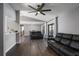 Spacious living room with luxury vinyl plank flooring, ceiling fan, and a sliding glass door to the backyard at 9501 Holbrook Dr, Orlando, FL 32817