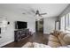 Large living room with wood flooring, ceiling fan, and television with fireplace at 9501 Holbrook Dr, Orlando, FL 32817