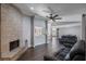 Open living area featuring a brick fireplace, luxury vinyl plank flooring, and an open-concept layout at 9501 Holbrook Dr, Orlando, FL 32817