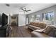 Spacious living room filled with natural light, ceiling fan, and wood flooring at 9501 Holbrook Dr, Orlando, FL 32817