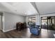 Living room with luxury vinyl plank flooring, a dining table, and sliding glass doors to the backyard at 9501 Holbrook Dr, Orlando, FL 32817