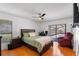Bright main bedroom features a ceiling fan, wood floors, and sliding glass doors to the pool at 9501 Holbrook Dr, Orlando, FL 32817