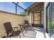Enclosed patio with two chairs and a table; light from the blue sky highlights the area at 9501 Holbrook Dr, Orlando, FL 32817