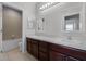 Bright bathroom featuring a double vanity with a tile floor and combination tub and shower at 9899 Leland Dr, Orlando, FL 32827