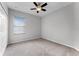 Bedroom featuring carpeted floors, a ceiling fan and window with blinds at 9899 Leland Dr, Orlando, FL 32827