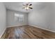 Bedroom featuring neutral walls, wood-look flooring, a ceiling fan, and bright natural light at 9899 Leland Dr, Orlando, FL 32827