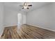 Bonus room with wood-look flooring, neutral walls, ceiling fan, and bright natural light at 9899 Leland Dr, Orlando, FL 32827