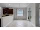 Cozy dining area featuring tiled floors, window, pendant lighting, and backyard access at 9899 Leland Dr, Orlando, FL 32827