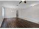 Open living room featuring ceiling fan, hardwood floors, and neutral paint at 9899 Leland Dr, Orlando, FL 32827