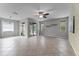 Spacious living room with tiled floors, ceiling fan, and sliding glass door at 9899 Leland Dr, Orlando, FL 32827