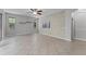Bright and airy living room featuring unique stone wall and tile flooring at 9899 Leland Dr, Orlando, FL 32827