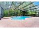 Inviting screened pool area surrounded by lush greenery for ultimate privacy at 9899 Leland Dr, Orlando, FL 32827
