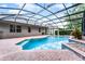 Inviting pool area with brick patio, ideal for relaxation, within screened enclosure at 9899 Leland Dr, Orlando, FL 32827