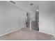 Neutral upstairs landing featuring carpeted floors and white doors at 9899 Leland Dr, Orlando, FL 32827