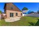 Green backyard features a patio, lawn, and a white fence providing privacy for outdoor enjoyment at 10020 Creekwater Blvd, Orlando, FL 32825