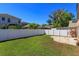 Large grassy backyard features a white fence providing a private area for outdoor enjoyment at 10020 Creekwater Blvd, Orlando, FL 32825
