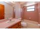 Full bathroom with shower-tub combo, window, and vanity with plenty of counter space at 10020 Creekwater Blvd, Orlando, FL 32825