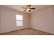 Cozy bedroom with ceiling fan, neutral carpeting, and window offering natural light at 10020 Creekwater Blvd, Orlando, FL 32825