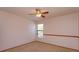 Comfortable bedroom featuring neutral carpet, ceiling fan, and bright window at 10020 Creekwater Blvd, Orlando, FL 32825