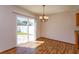 Dining area with laminate flooring, sliding glass doors, and modern light fixture at 10020 Creekwater Blvd, Orlando, FL 32825