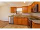 Cozy kitchen with granite countertops, stainless steel dishwasher, and a view from the window at 10020 Creekwater Blvd, Orlando, FL 32825